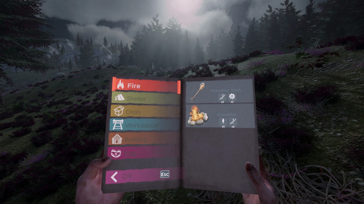 มือผู้เล่นถือหนังสือเมนู มีหมวด Fire และ Shelter พร้อมภาพ Standing Torch และ Campfire ท่ามกลางป่า